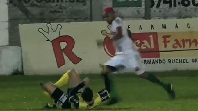 Brazilian player kicking a refree
