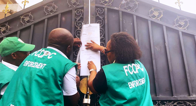 FCCPC pasting the summons on the gate of the Chinese supermarket in Abuja on Monday, April 22, 2024 FCCPC Chinese