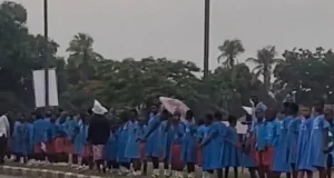 Benue pupils stand in rain to welcome Tinubu