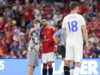 Pitch invaders take selfies with Fernandes during Man United match United