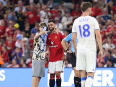 Pitch invaders take selfies with Fernandes during Man United match United