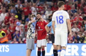 Pitch invaders take selfies with Fernandes during Man United match United